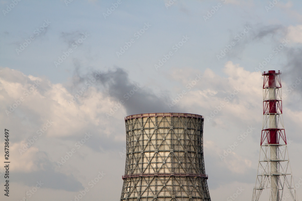 Thermal power station. Smoke from the pipes. Sunny day, blue sky background.