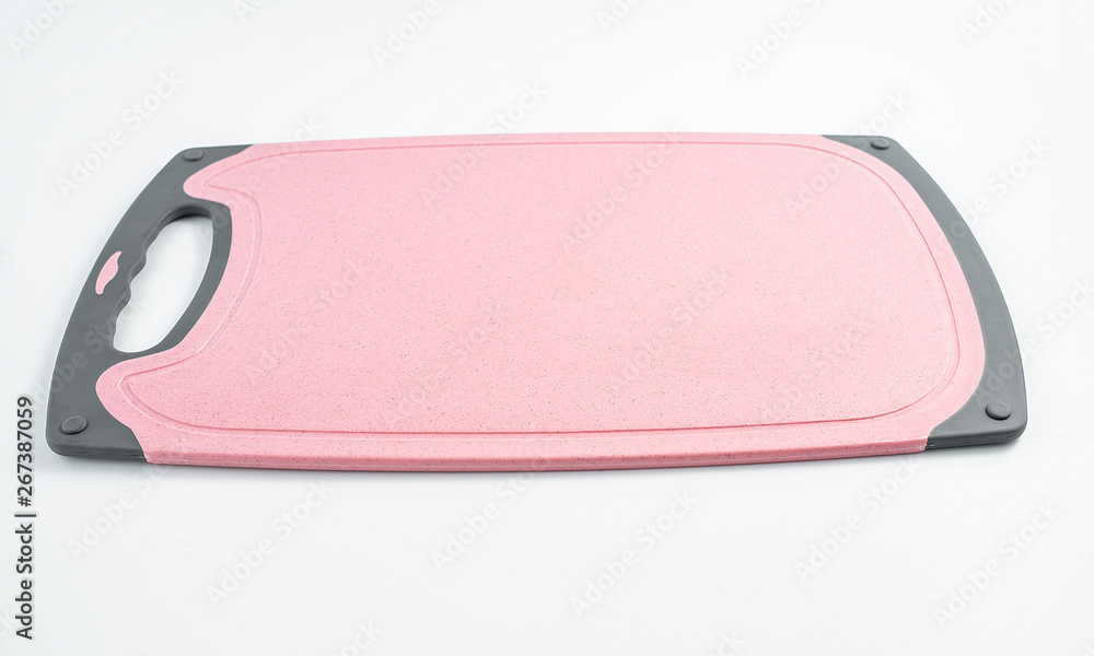Piece of red plastic chopping board on white background Piece of red plastic chopping board on white background