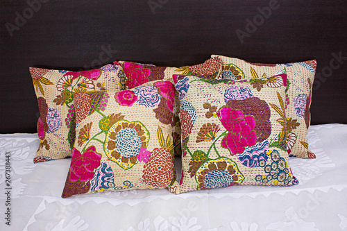 Flower printed traditional ethnic cushions on bed