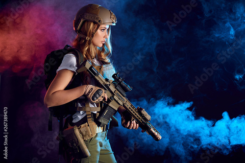 Quadro su tela Female storm trooper in military camouflage uniform protected with helmet, body