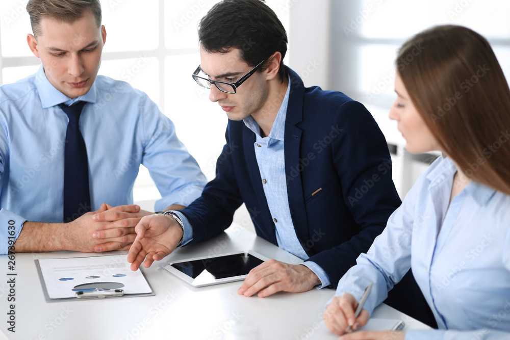 Group of business people discussing questions at meeting in modern office. Managers at negotiation or brainstorm. Teamwork, partnership and business concept Group of business people discussing questions at meeting in modern office. Managers at negotiation or brainstorm. Teamwork, partnership and business concept
