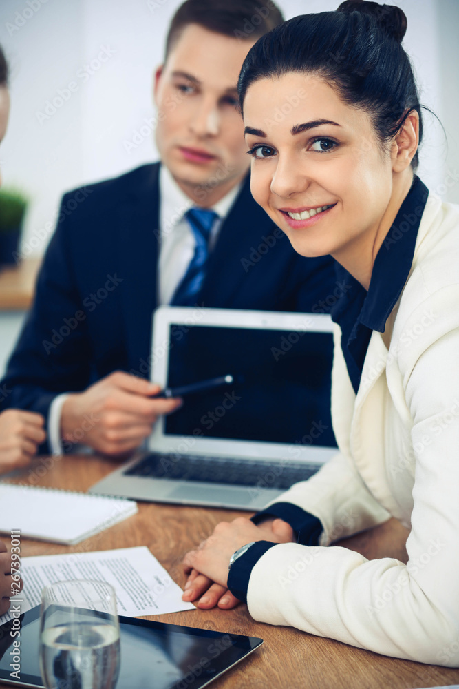 Group of business people and lawyers discussing contract papers Group of business people and lawyers discussing contract papers