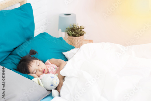 Asian little  girl sleeping in the bedroom.
