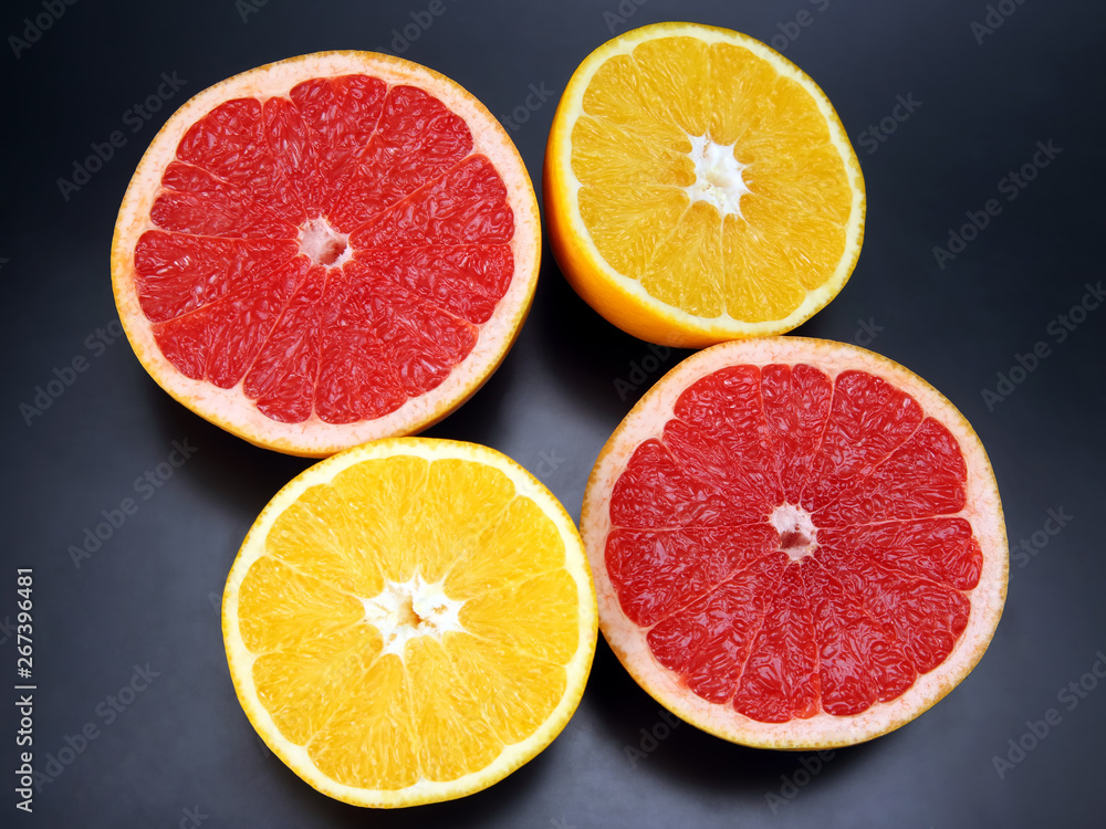 Citrus fruit. Cut orange and grapefruit on dark background Citrus fruit. Cut orange and grapefruit on dark background