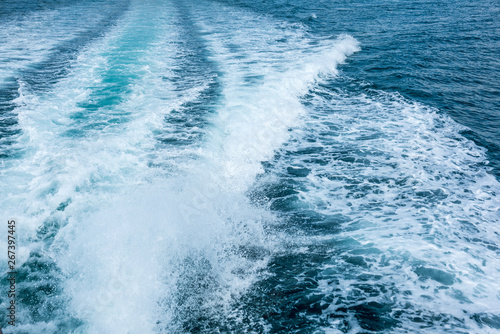 Water splash behind the ship or wake of speed boat in the ocean