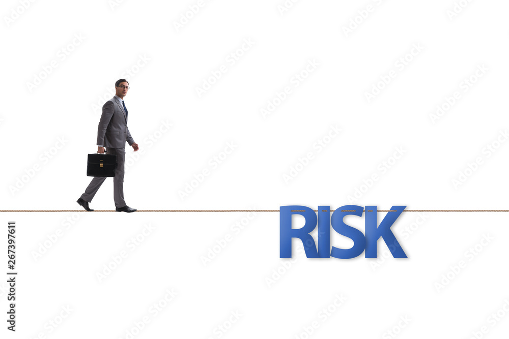 Businessman in risk concept walking on tight rope Businessman in risk concept walking on tight rope