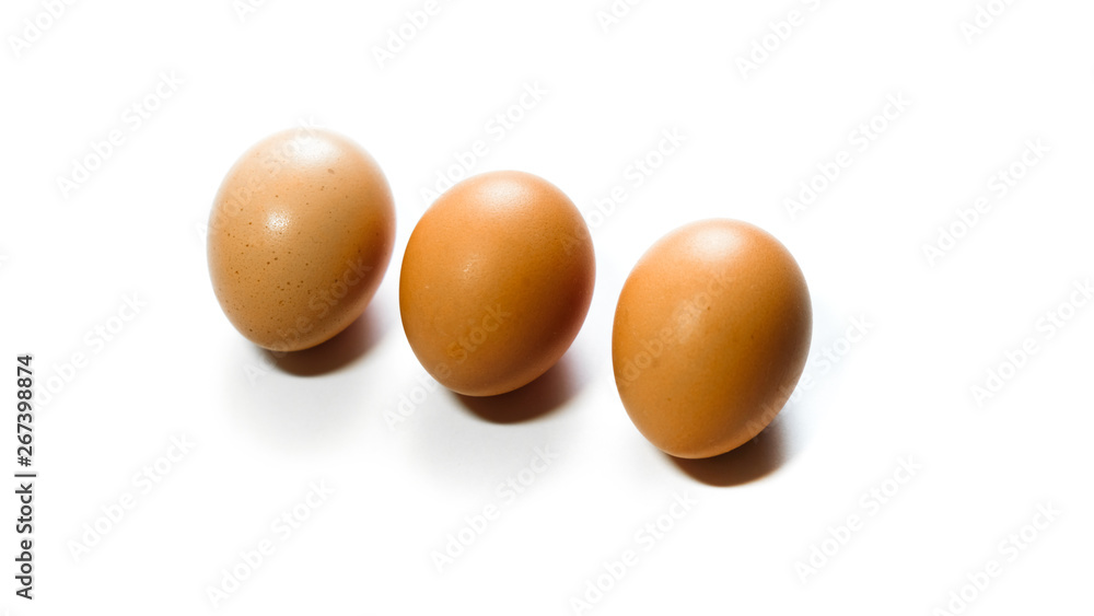 three brown eggs isolated on white background three brown eggs isolated on white background