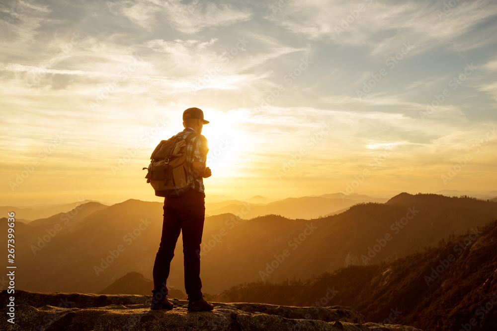 Hiker meets the sunset on the Moro rock in Sequoia national park, California, USA.