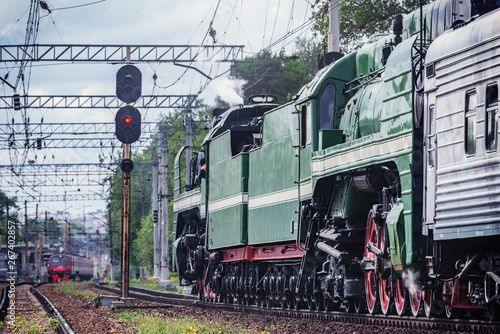 Retro steam train approaches to the station.