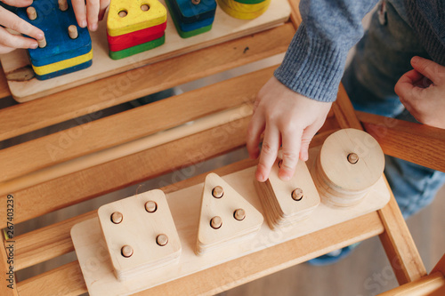 child playing with wooden educational toys
