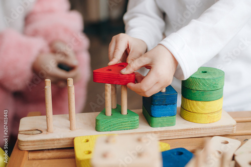 child playing with wooden educational toys