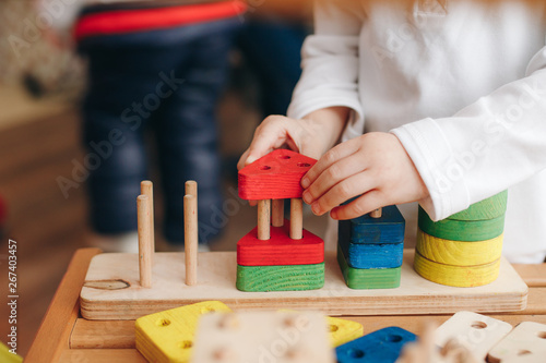 child playing with wooden educational toys