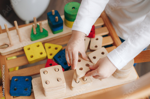 child playing with wooden educational toys