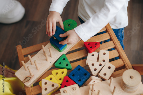 child playing with wooden educational toys
