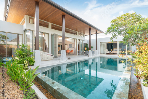 home or house building Exterior and interior design showing tropical pool villa with green garden © Stock PK