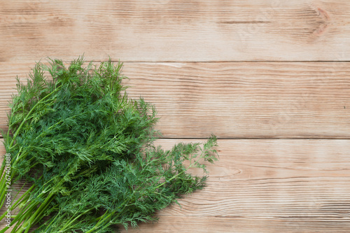 Fresh green organic dill on a wooden background.