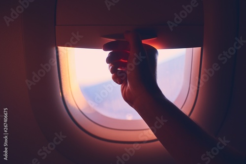Obraz na plátně Close-up airplane window at sunrise