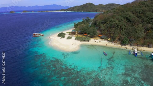 Panorama of the tropical sandy beach Malcapuya and azure sea in Coron, Busuanga island, Palawan, Philippines. Aerial view 4K photo