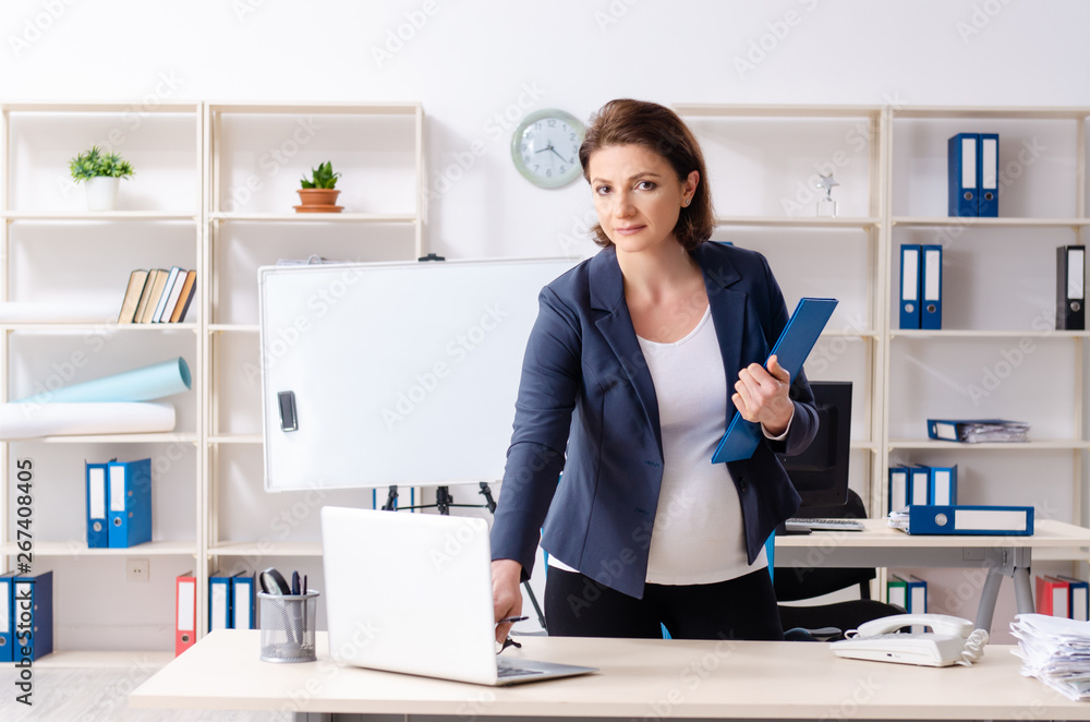 Experienced female employee working in the office 