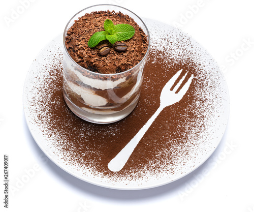 Classic tiramisu dessert in a glass on plate with fork silhouette isolated on a white with clipping path