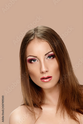 Portrait of sexy beautiful woman dark pink make-up on background salmon shade red