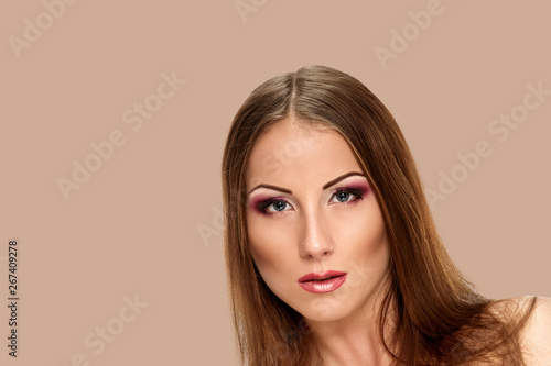 Beautiful sensual woman face on background salmon shade red