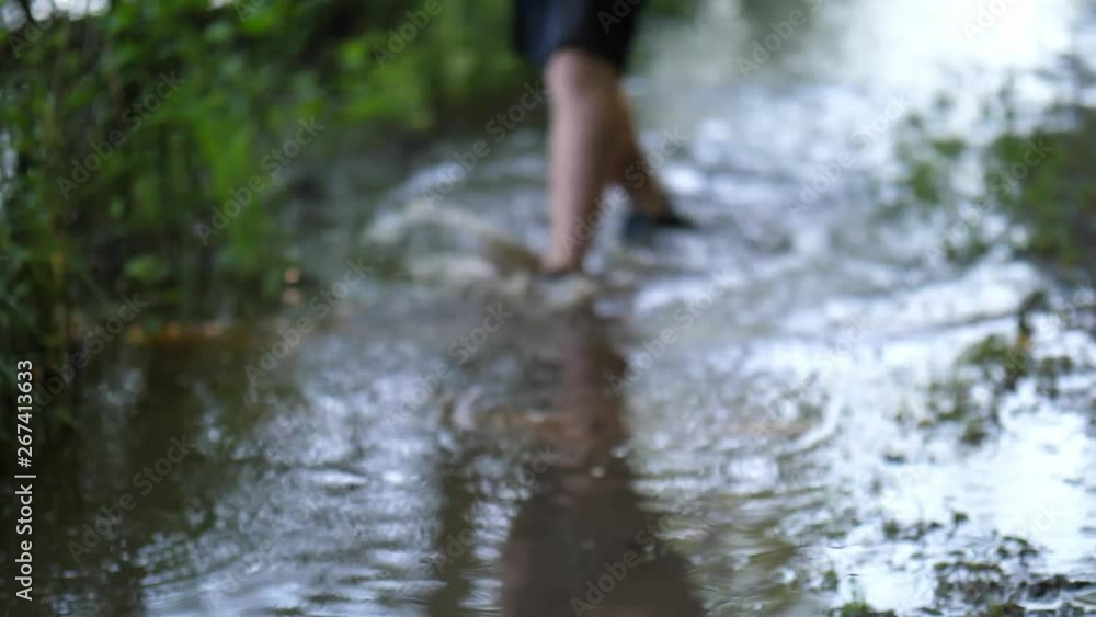 Kid walking and jumping in a puddle Kid walking and jumping in a puddle