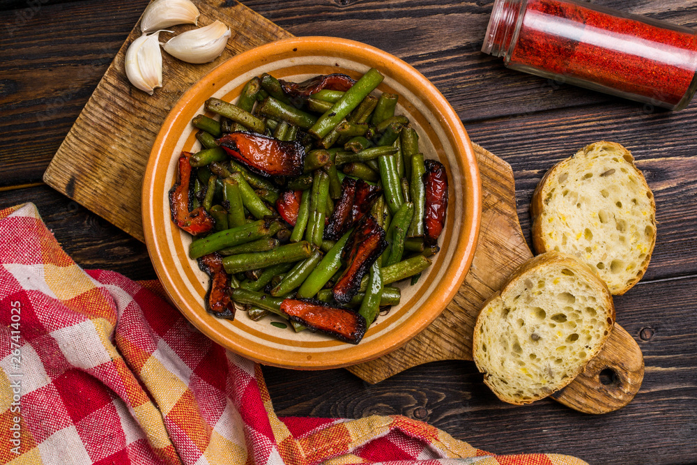 Fried green beans with red pepper, bread, garlic. Vegetarian food. Flat lay.