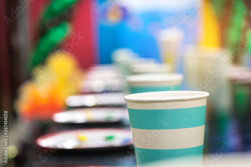 Paper cups on table and decoration prepared for kids birthday party. Blue theme baby boy.