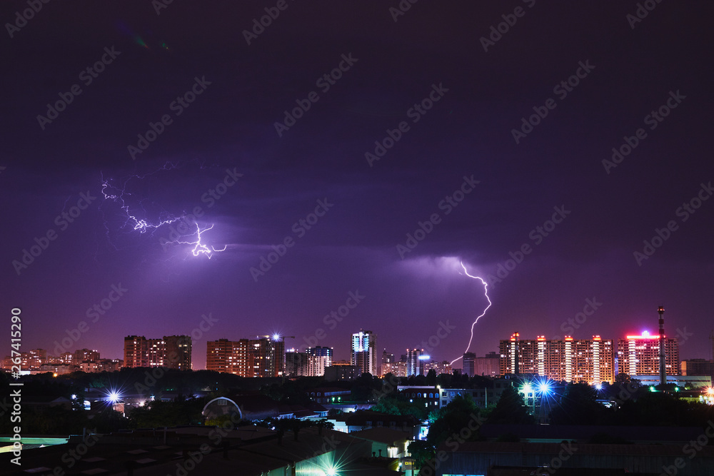Night thunder lightning over the city sky view.
