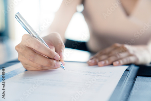 business investor woman success deal contract with paper sign close up hand hold pen sign contract photo