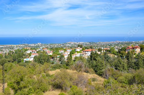 Amazing view over small city Bellapais in Kyrenia region, Northern Cyprus. The view point is overlooking the Mediterranean sea and adjacent subtropical landscape. Blue sky above. Popular tourist spot