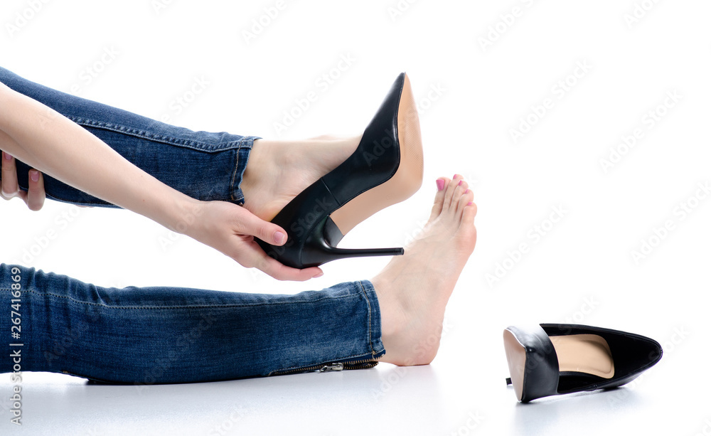 Female legs in jeans black high heels beauty pain on white background isolation
