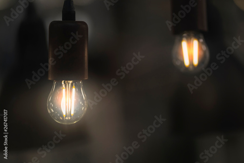 close up vintage light bulb with glowing light color tone effect