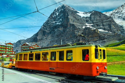 Picturesque place with mountains and old tourist train, Grindelwald, Switzerland
