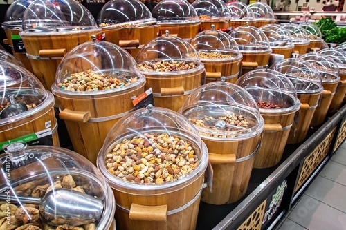 Dried fruits for sale on the market in wooden buckets with lids © Franco Nadalin