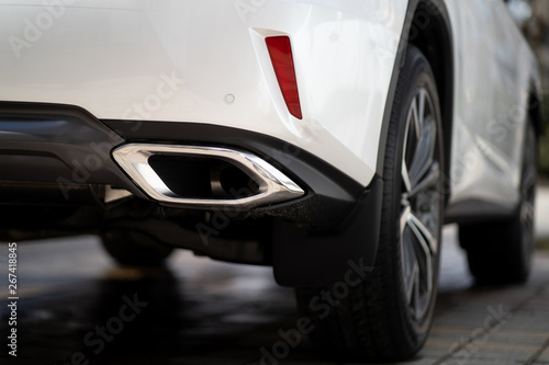 Close up photo of modern luxury sport car suv elegant design mufflers tailpipe. © B@rmaley