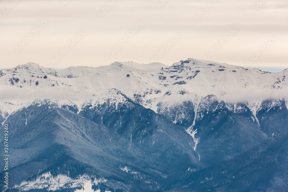 Winter snow covered mountain peaks in Brasov - Romania.
