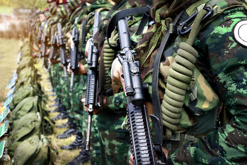 Thai soldiers stand in row.commando soldiers in camouflage uniforms gun in hand,close up of army and preparation for battle