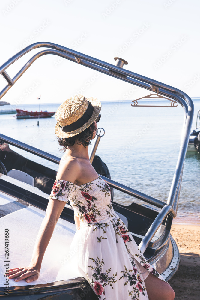  happy woman sitting on yacht and looking forward