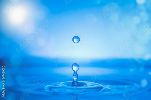 Water drop splash on water surface.