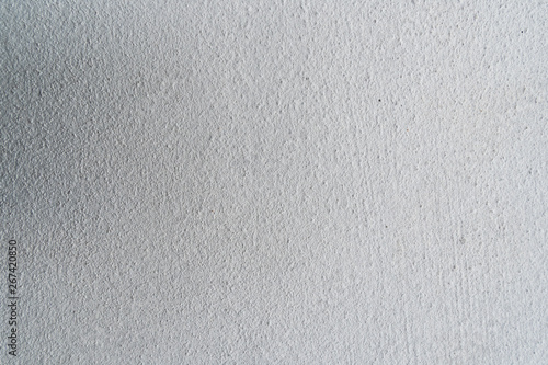 Texture of concrete wall surface painted with white color. Suitable for use as a pattern or background image for use in graphic design.