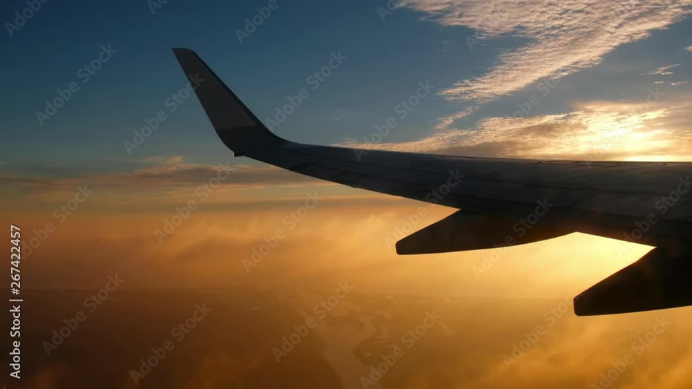 The view from the flying airplane window on cumulus clouds and wing of plain The view from the flying airplane window on cumulus clouds and wing of plain