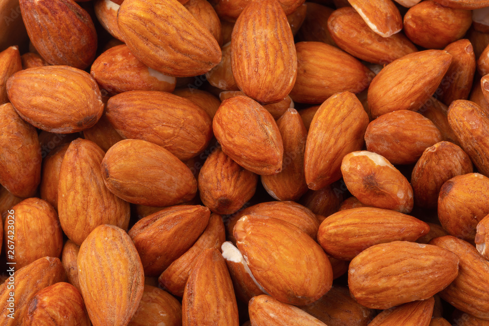 Almonds in wooden bowl isolated on a white background Almonds in wooden bowl isolated on a white background