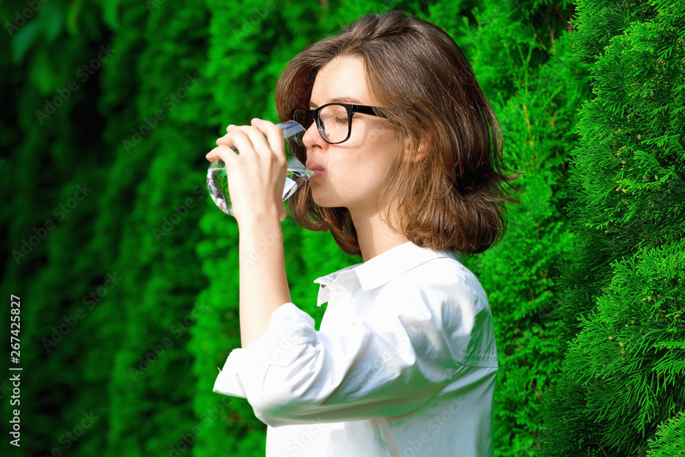 Young woman drinks water