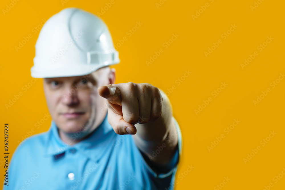brutal man Builder in a white helmet on a yellow background