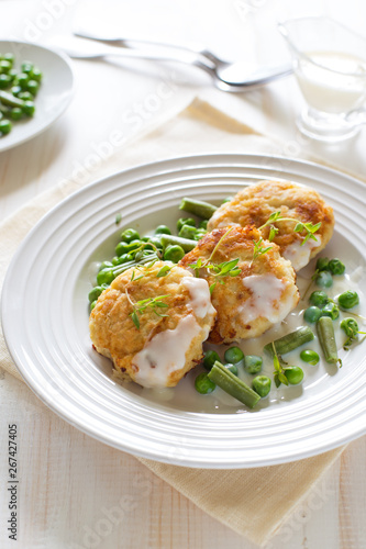 Fish cutlets with green peas and beans