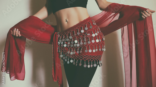 Close up stomach of belly dancer with scarf.Toned photo. photo