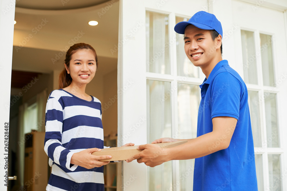 Delivery man and customer holding pizza Delivery man and customer holding pizza
