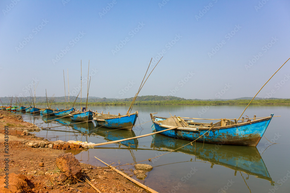old large shabby boats for the extraction of sand from the river anchored near the shore